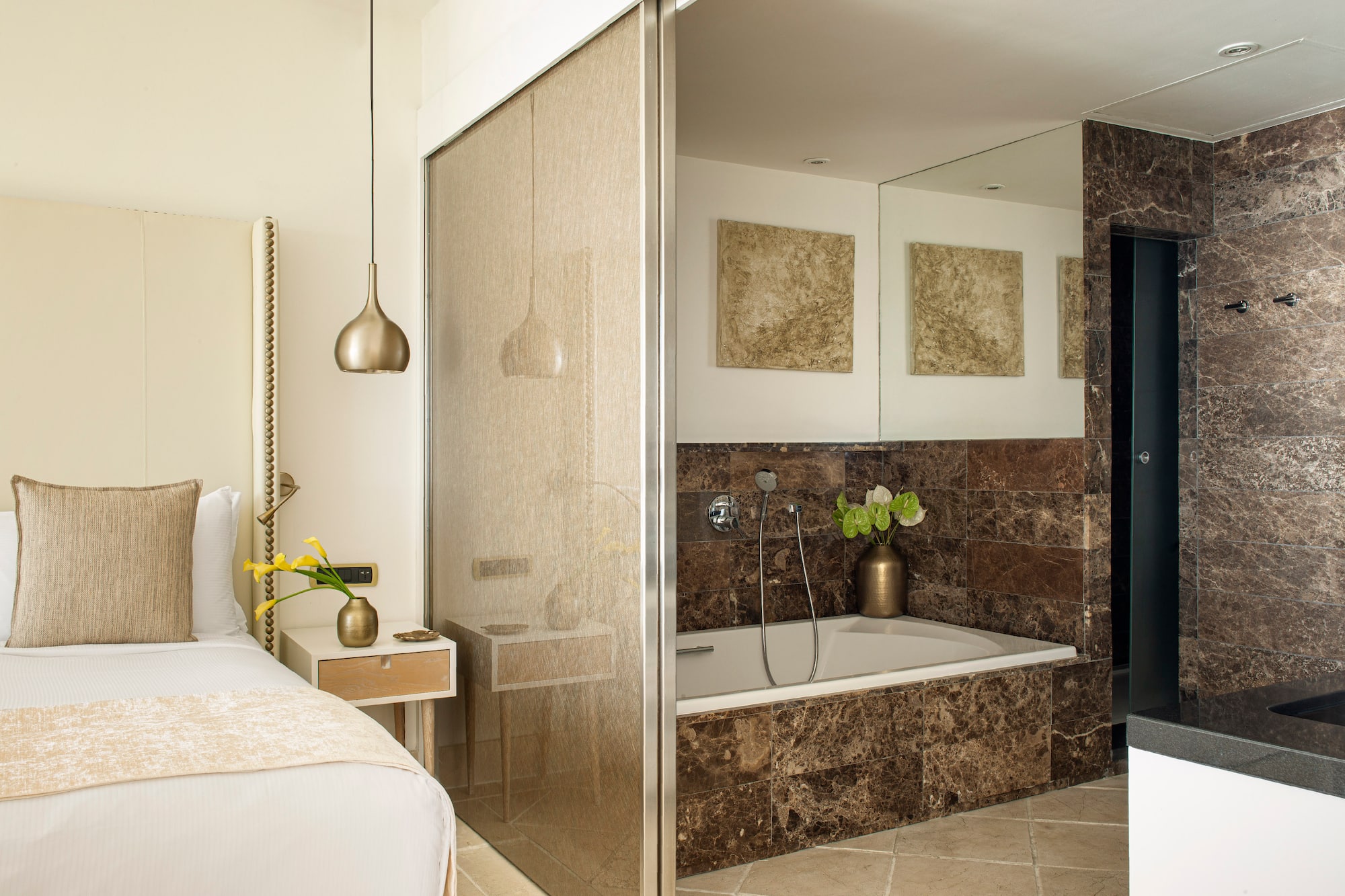 a bathroom with a bathtub and a bed