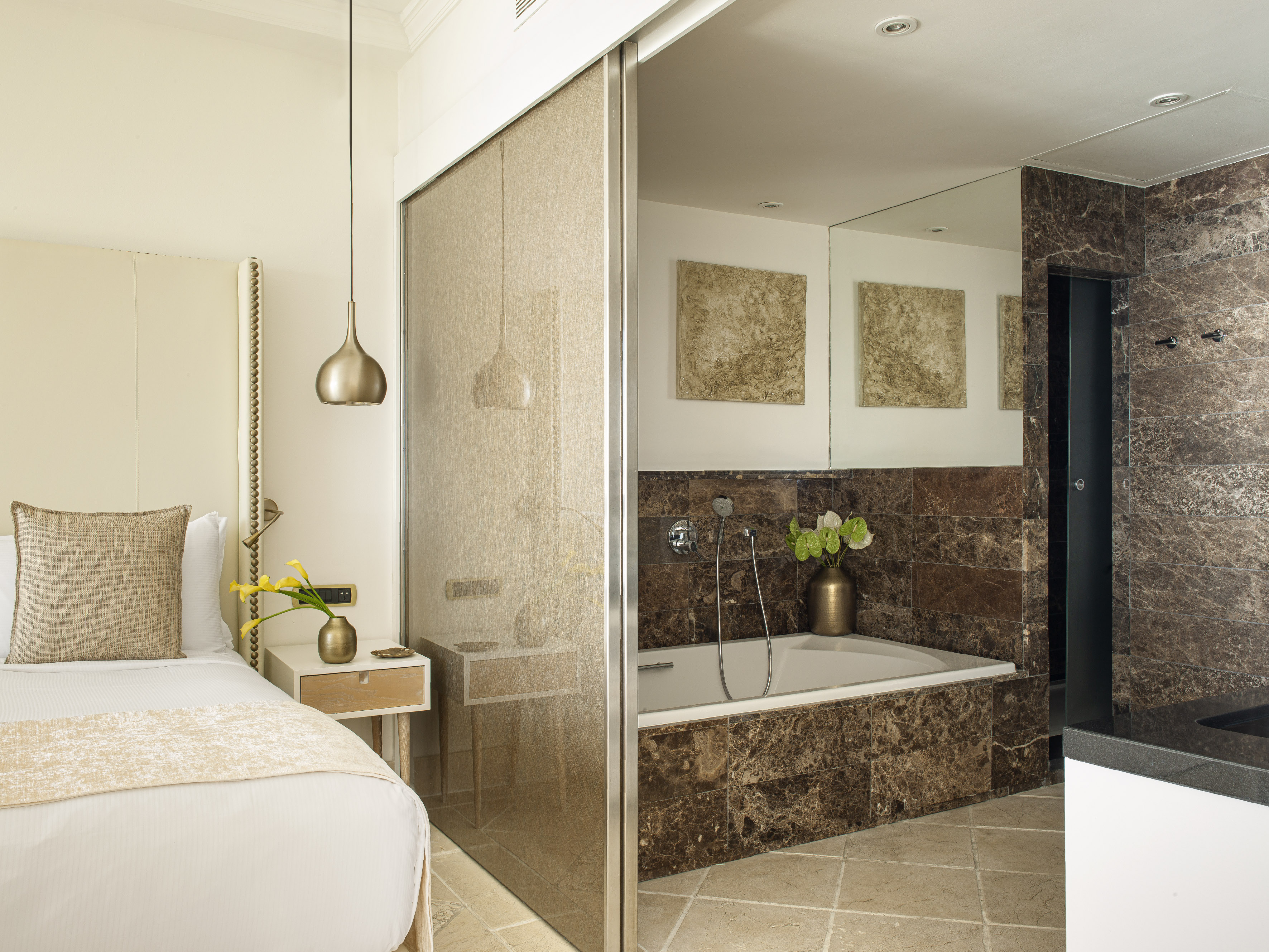 a bathroom with a bathtub and a bed