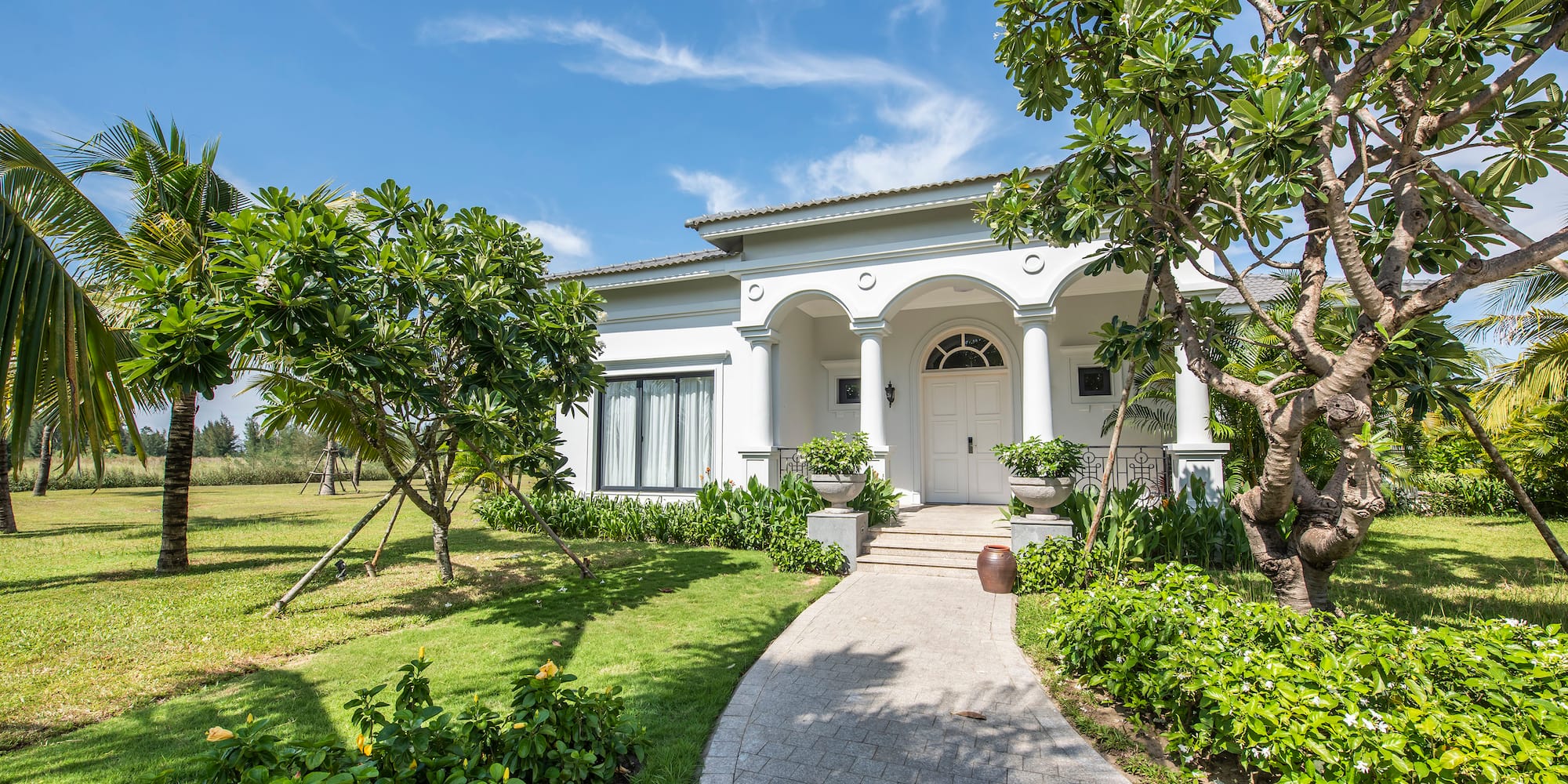 a white house with columns and a walkway