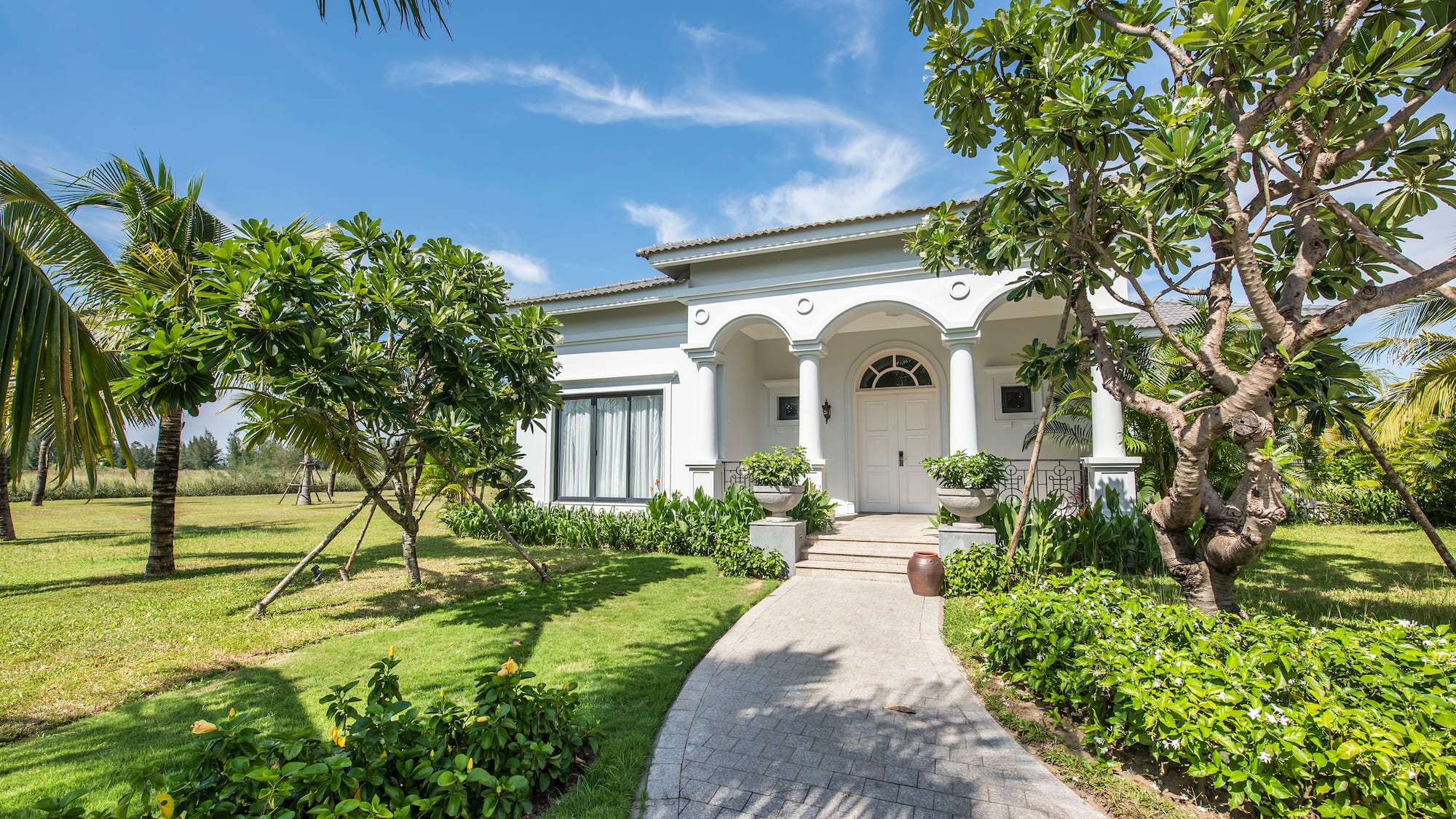 a white house with columns and a walkway