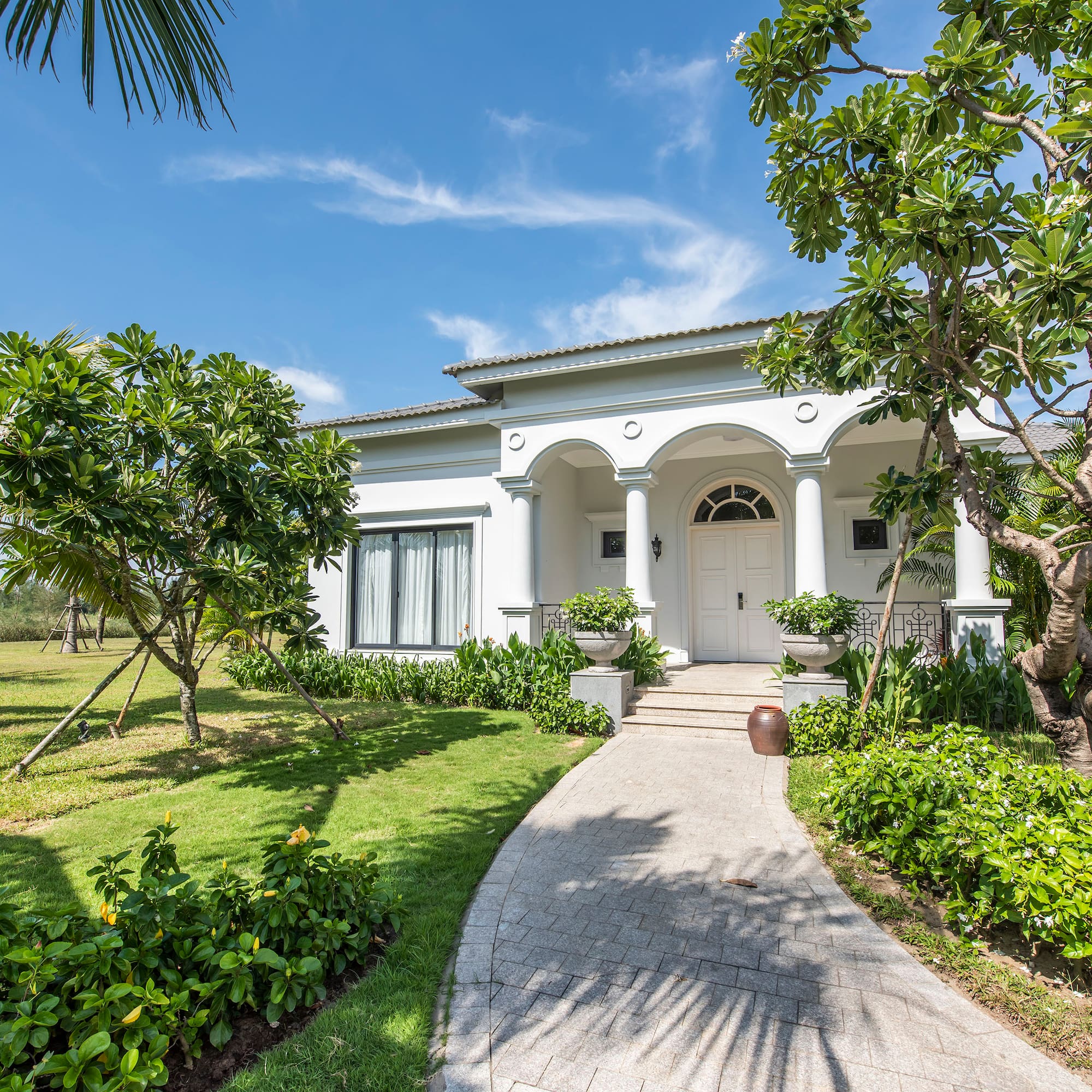 a white house with columns and a walkway
