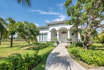 a white house with columns and a walkway