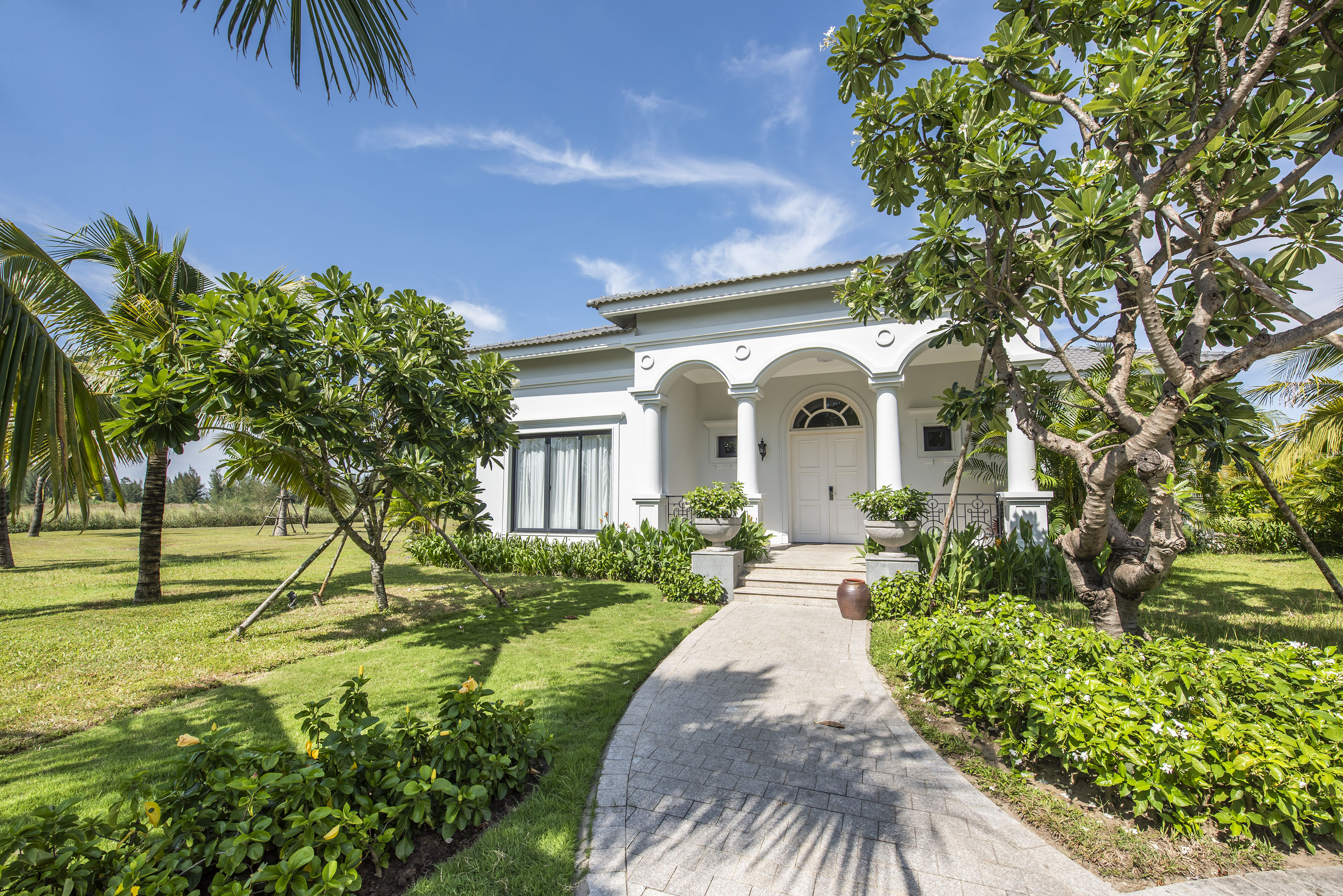 a white house with columns and a walkway