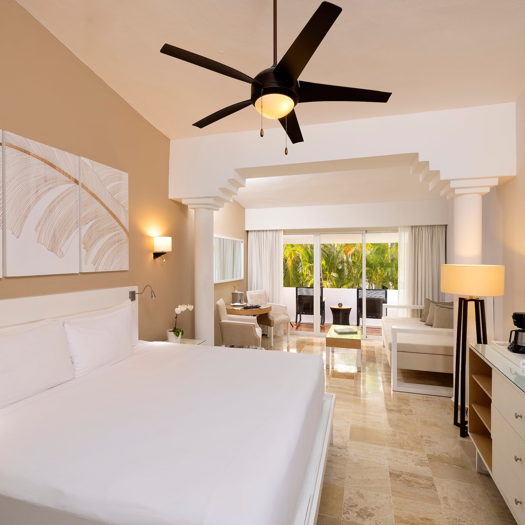 a room with a bed and a ceiling fan