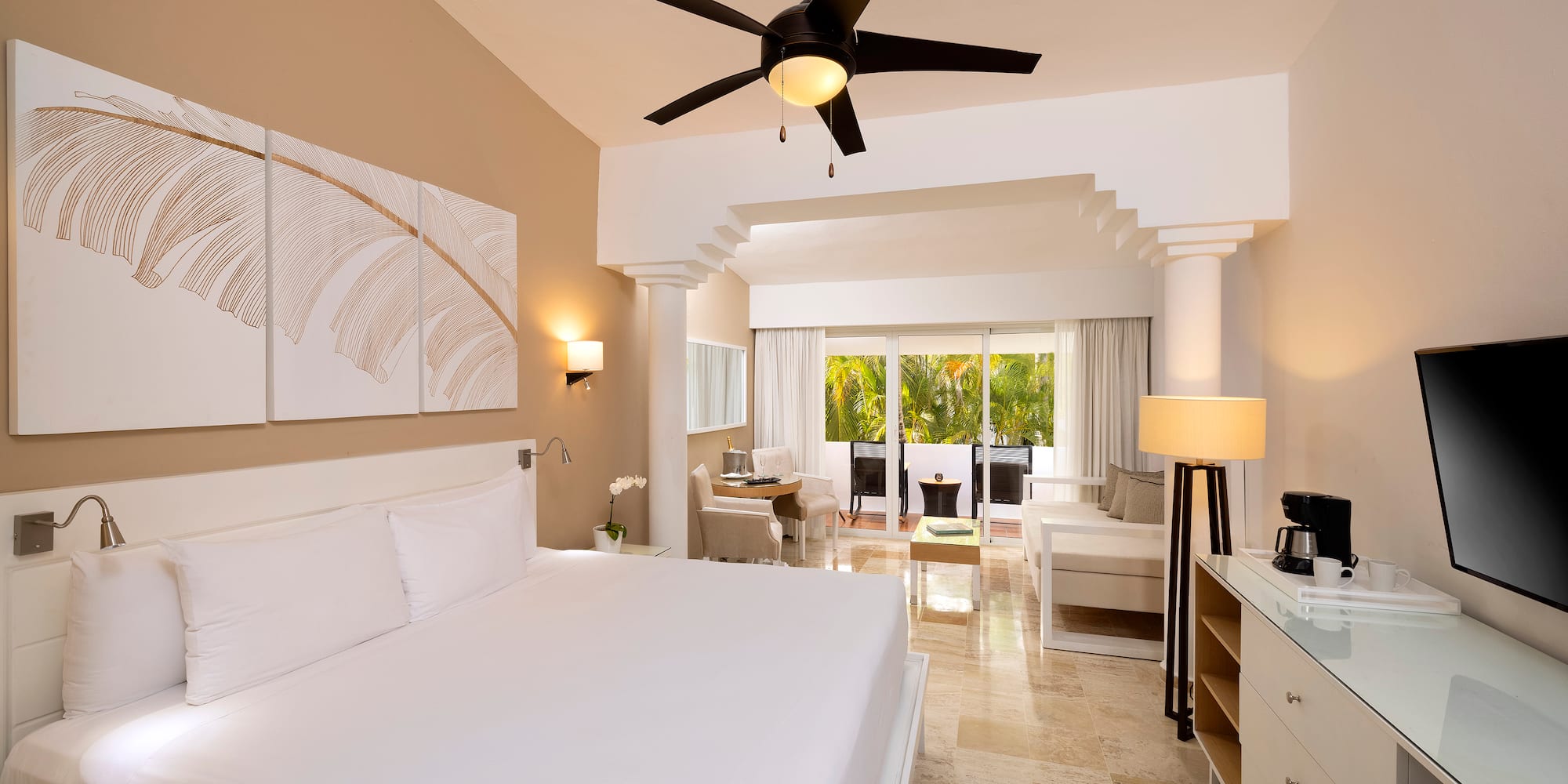 a room with a bed and a ceiling fan