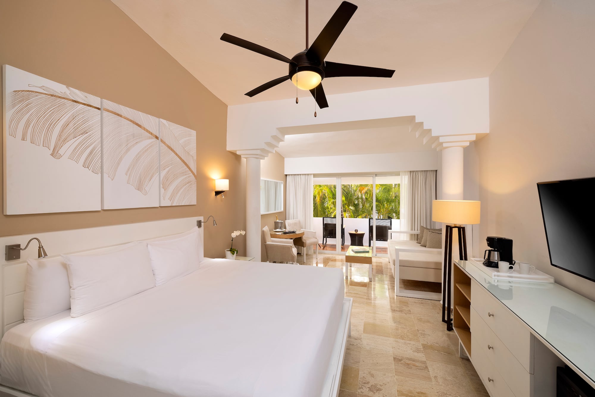 a room with a bed and a ceiling fan