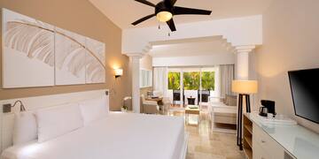 a room with a bed and a ceiling fan