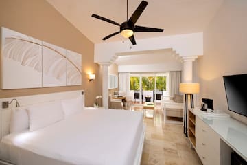 a room with a bed and a ceiling fan