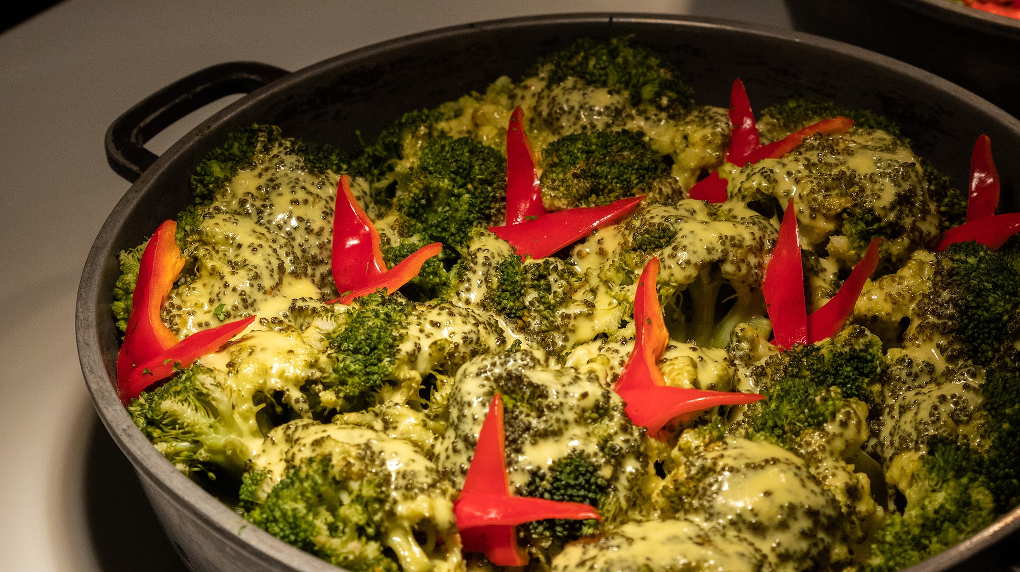 a pan of food with red peppers on top