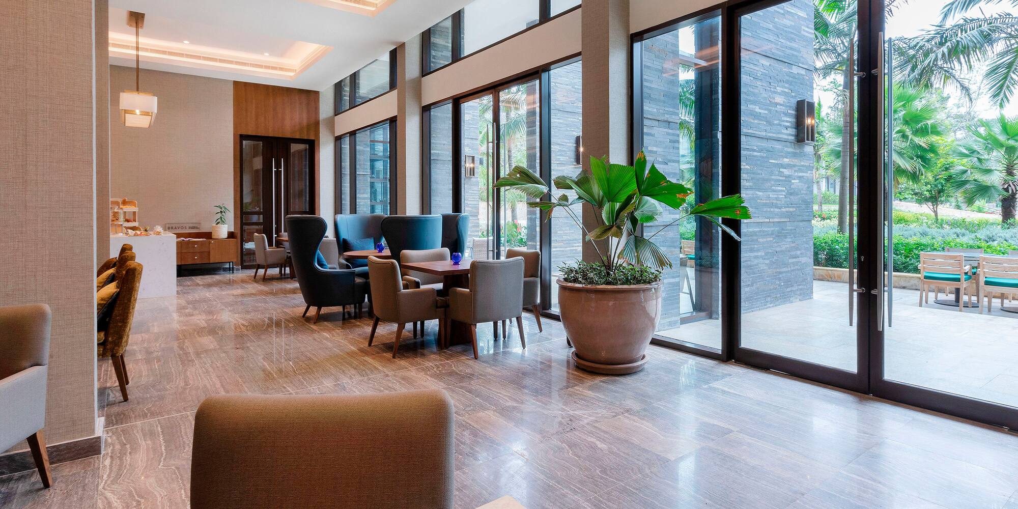 a room with large windows and chairs