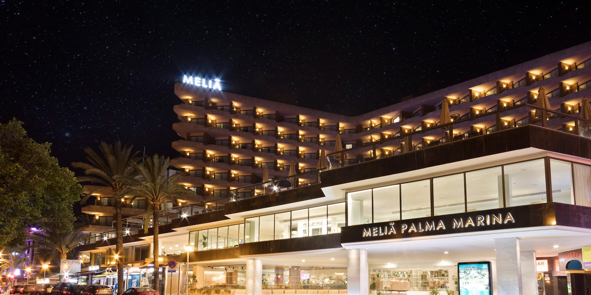 a building with many windows and a street at night