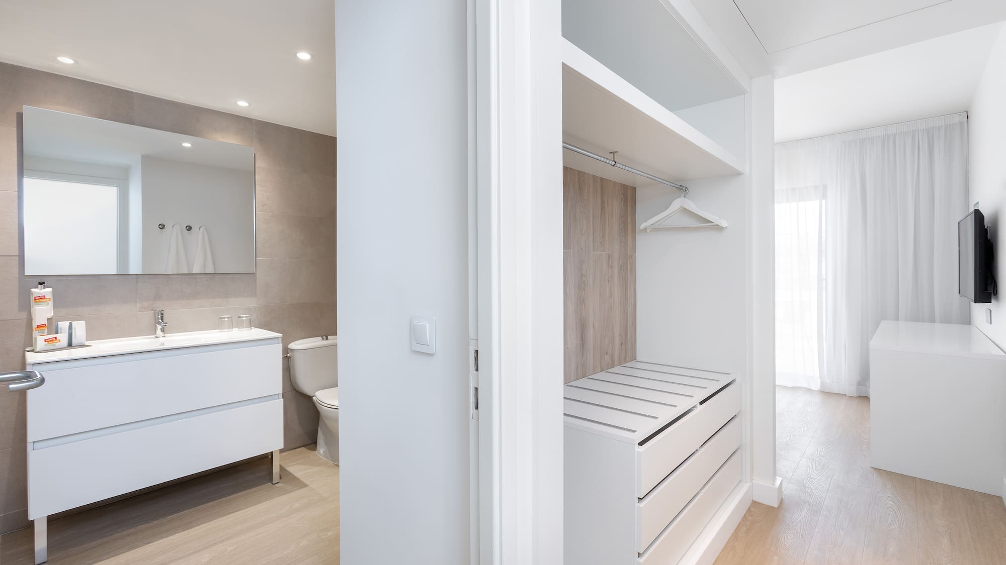 a white room with a closet and a toilet