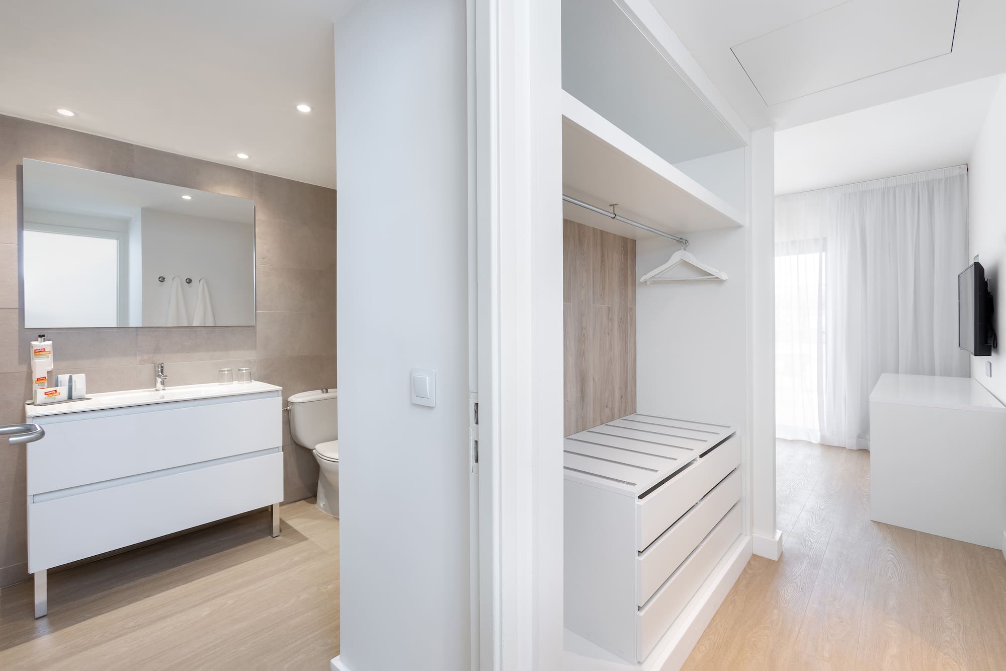 a white room with a closet and a toilet