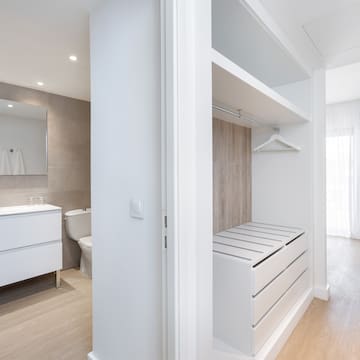 a white room with a closet and a toilet