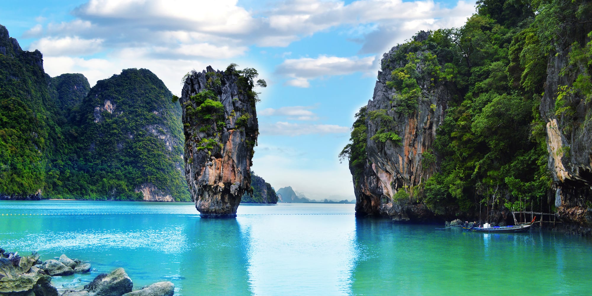a body of water with rocks and trees