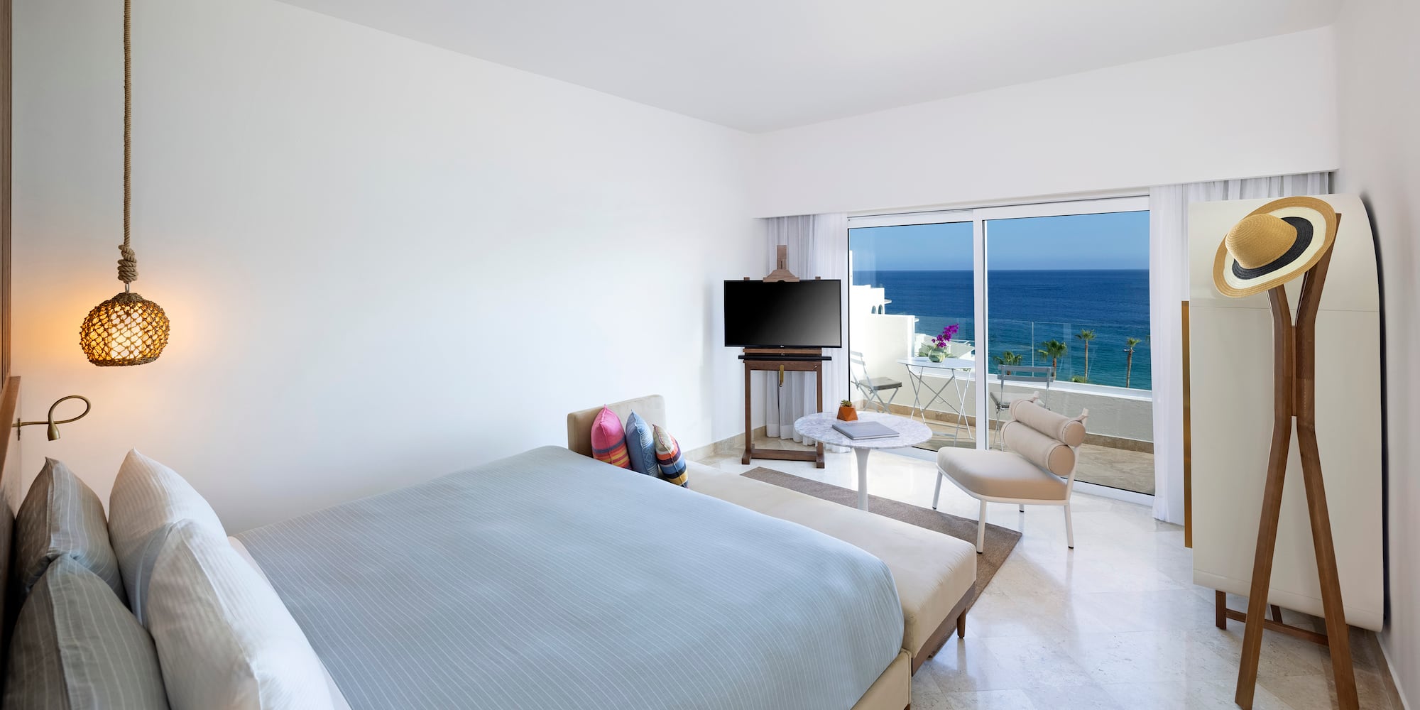 a bedroom with a television and a chair