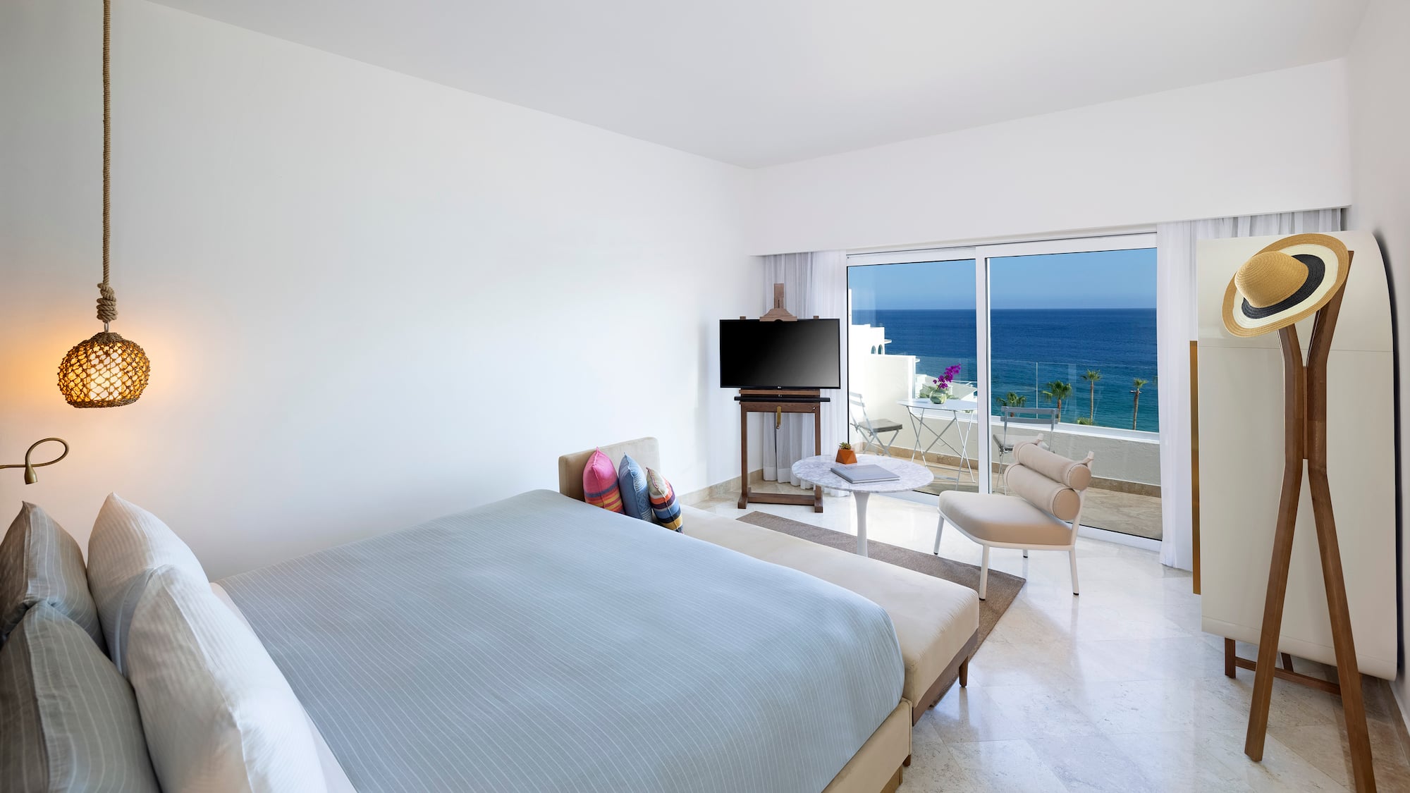 a bedroom with a television and a chair