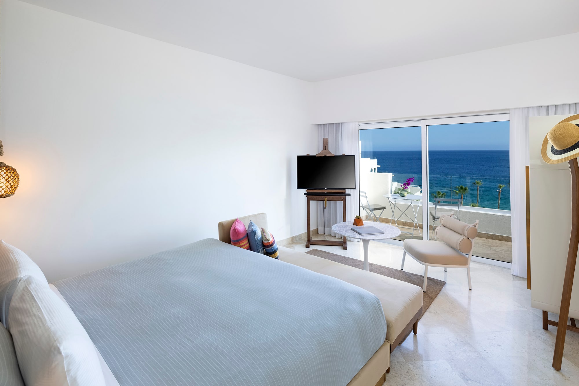 a bedroom with a television and a chair