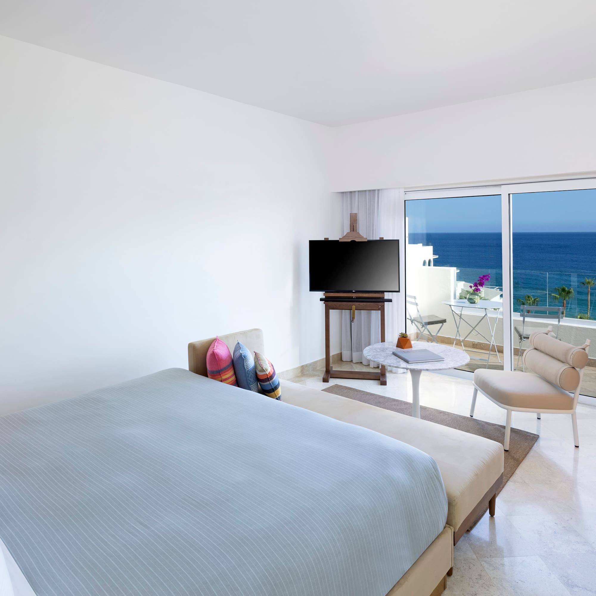 a bedroom with a television and a chair