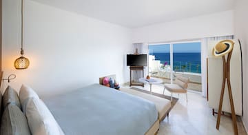 a bedroom with a television and a chair