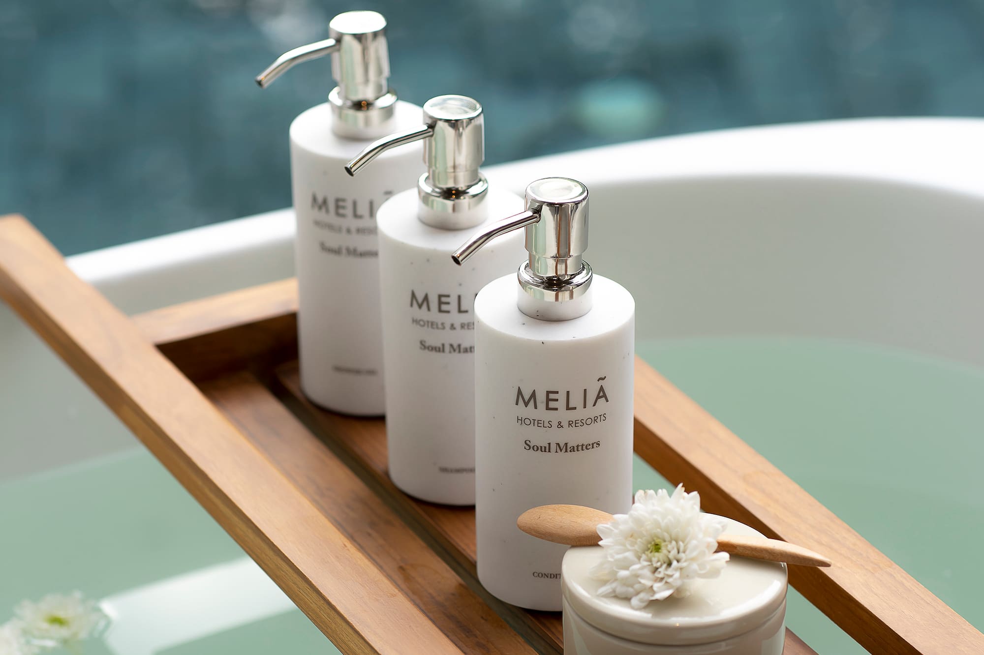 a group of white bottles on a wooden tray