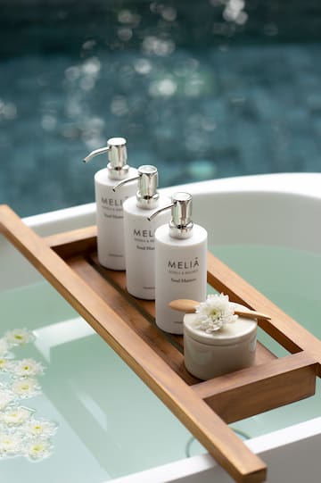 a group of white bottles on a wooden tray