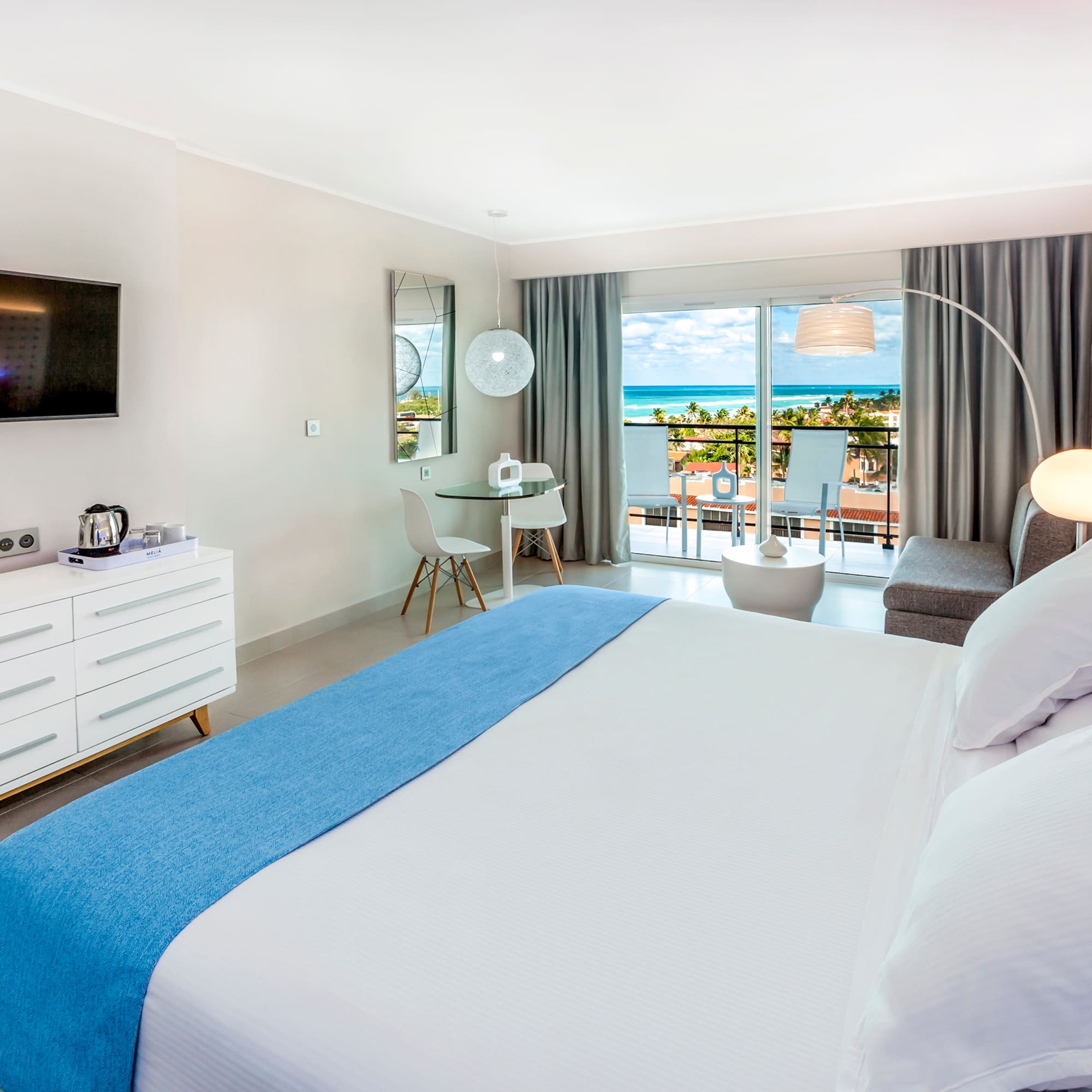 a bedroom with a large bed and a television