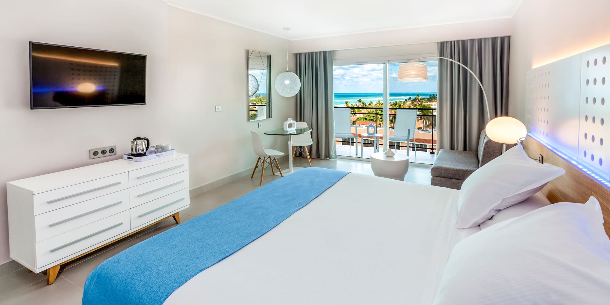 a bedroom with a large bed and a television