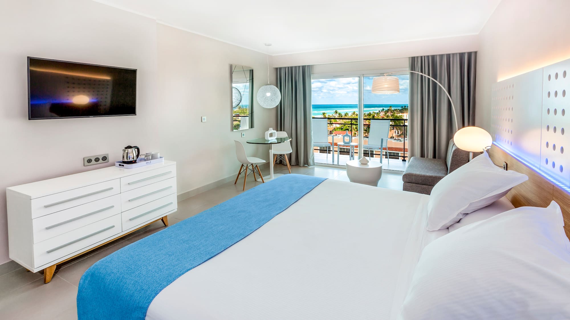 a bedroom with a large bed and a television