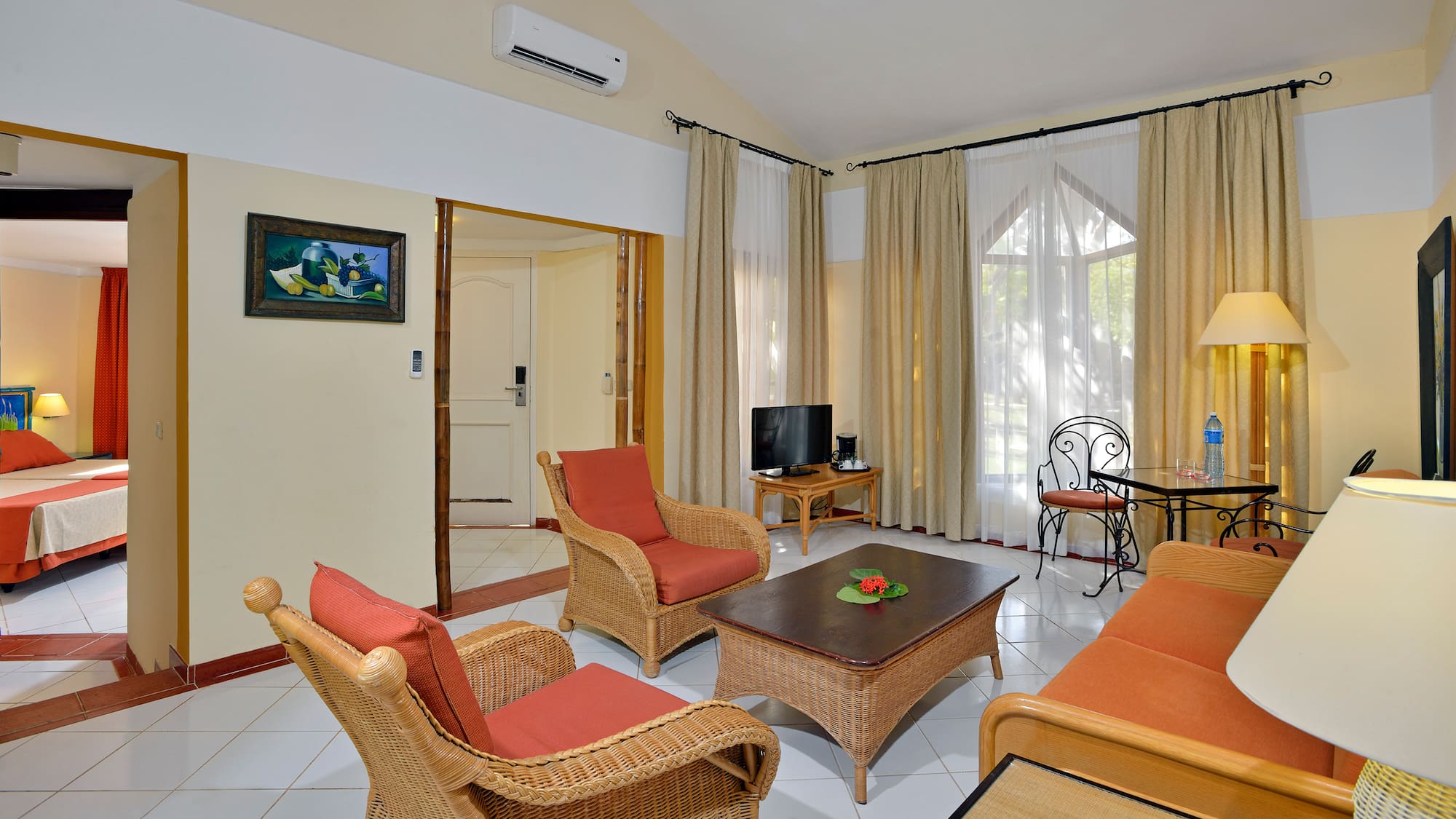 a living room with wicker furniture and a table