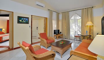 a living room with wicker furniture and a table