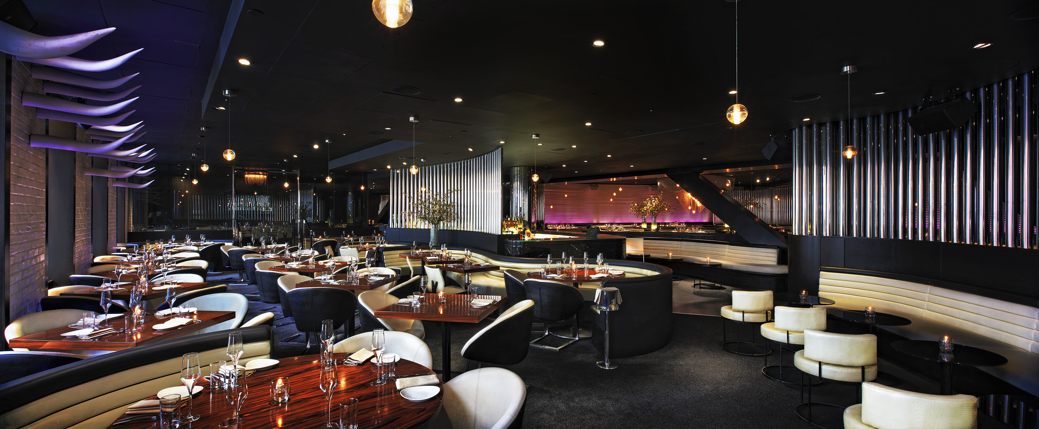 Elegant modern restaurant interior with fine dining tables and ambient lighting.