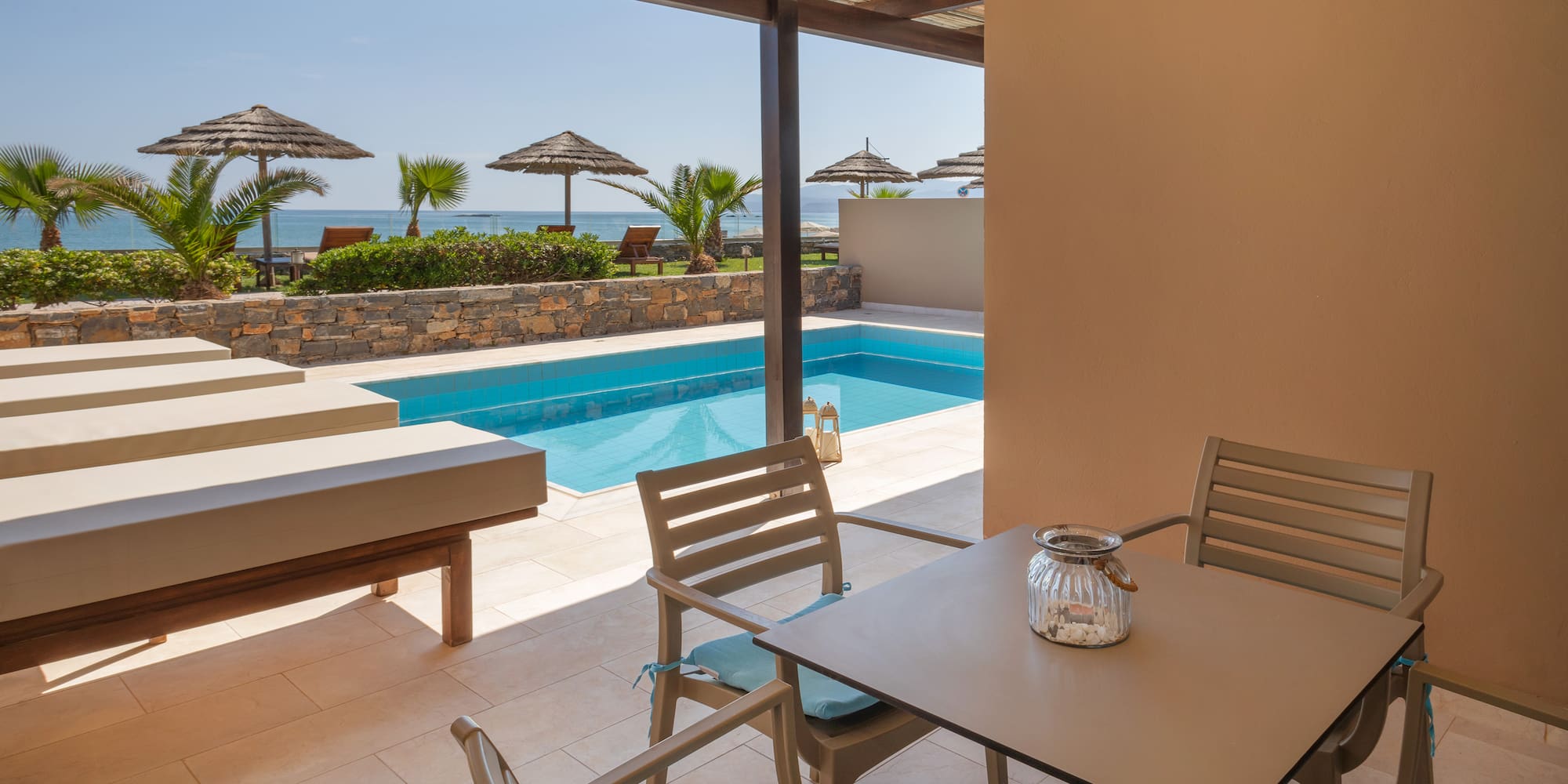 a patio with a pool and chairs