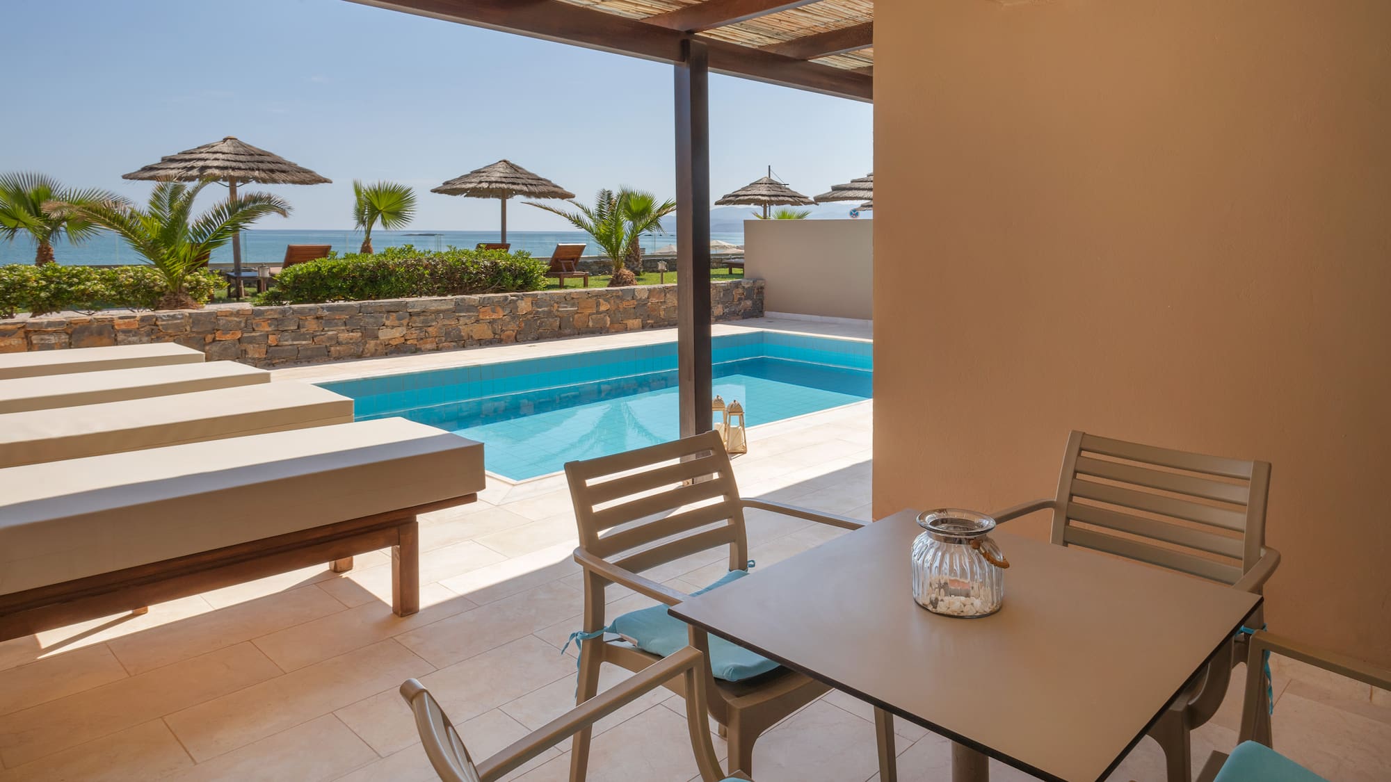 a patio with a pool and chairs