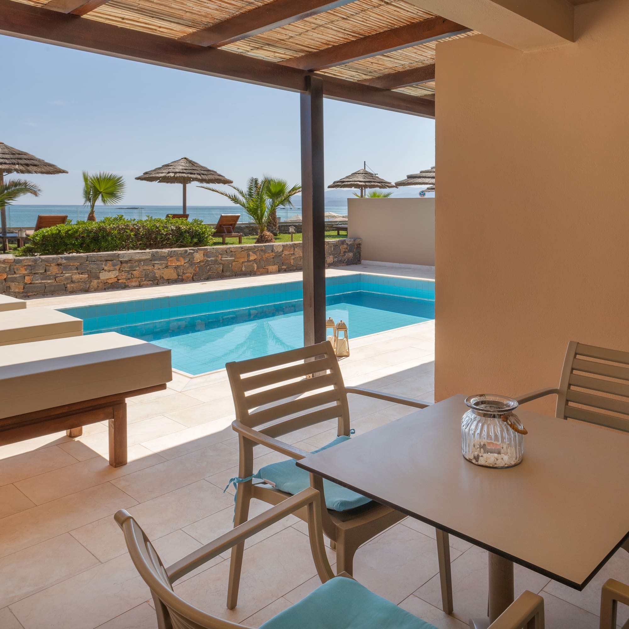 a patio with a pool and chairs