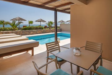 a patio with a pool and chairs