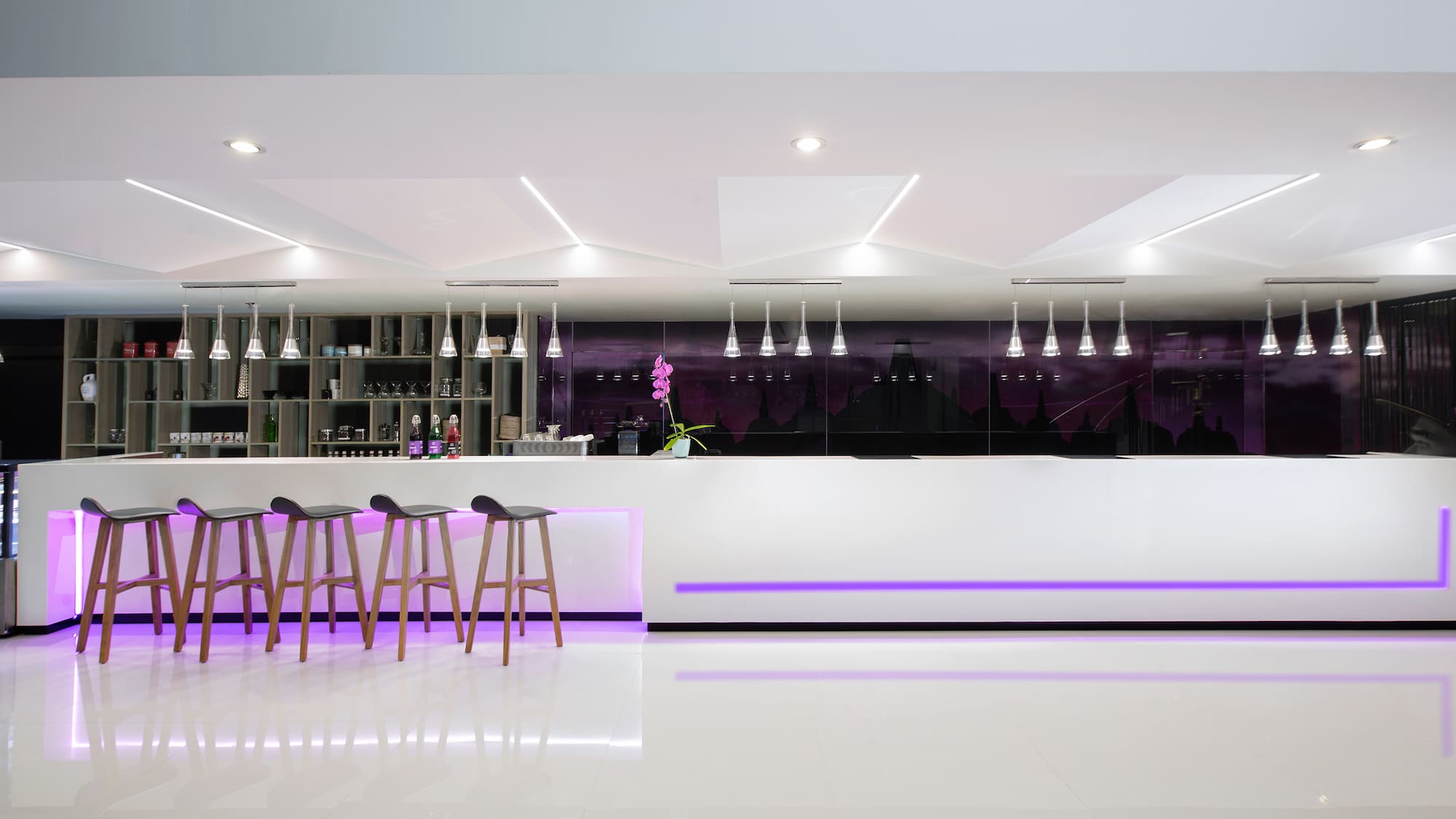 a bar counter with stools and lights