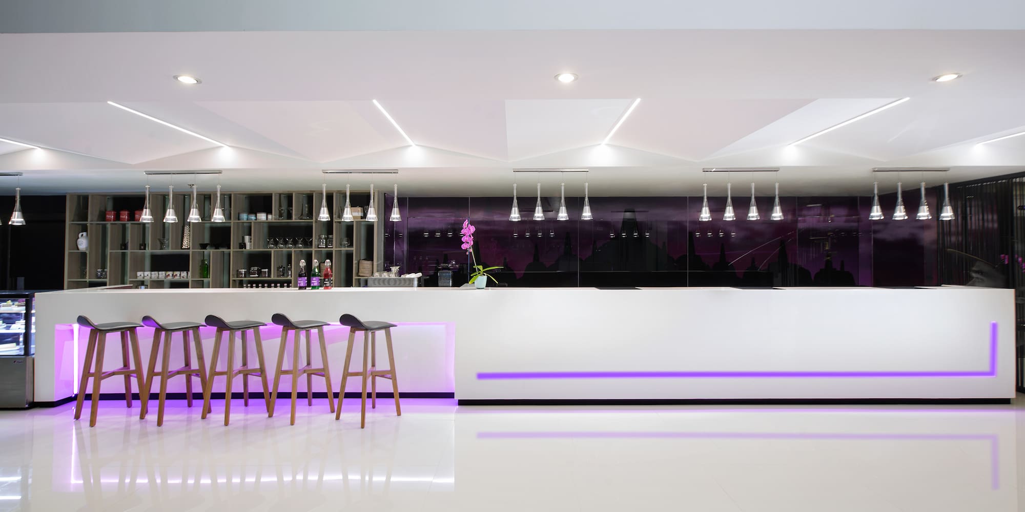 a bar counter with stools and lights