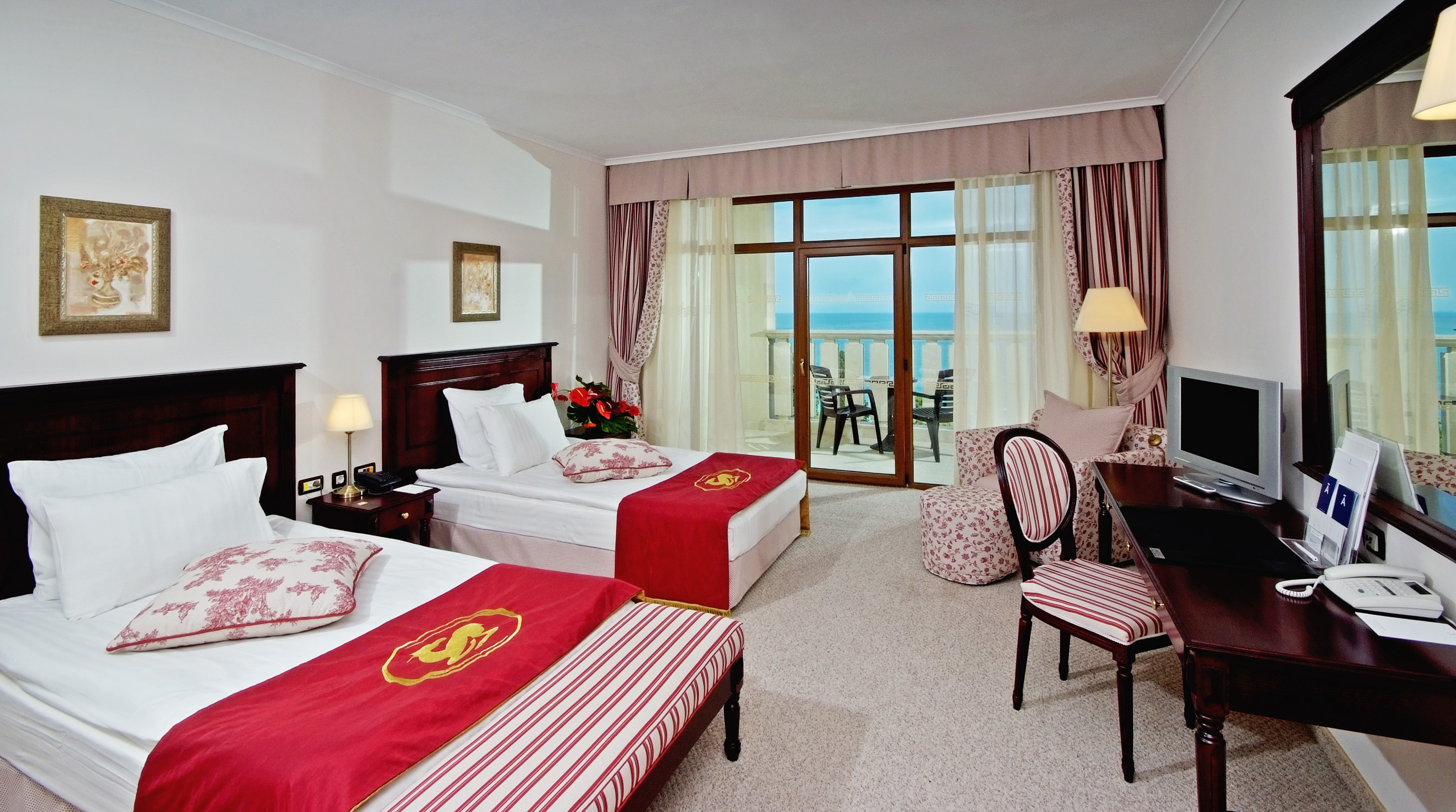 a hotel room with two beds and a table