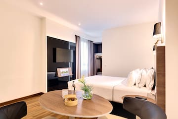 a room with a bed and a tv