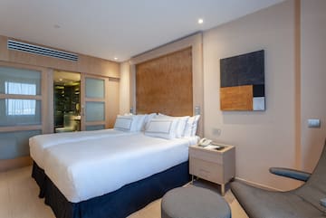 a bedroom with a bed and a table