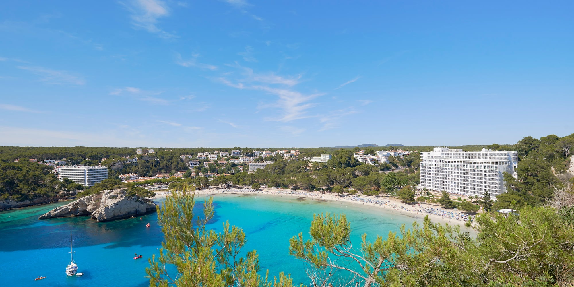 a beach with trees and buildings