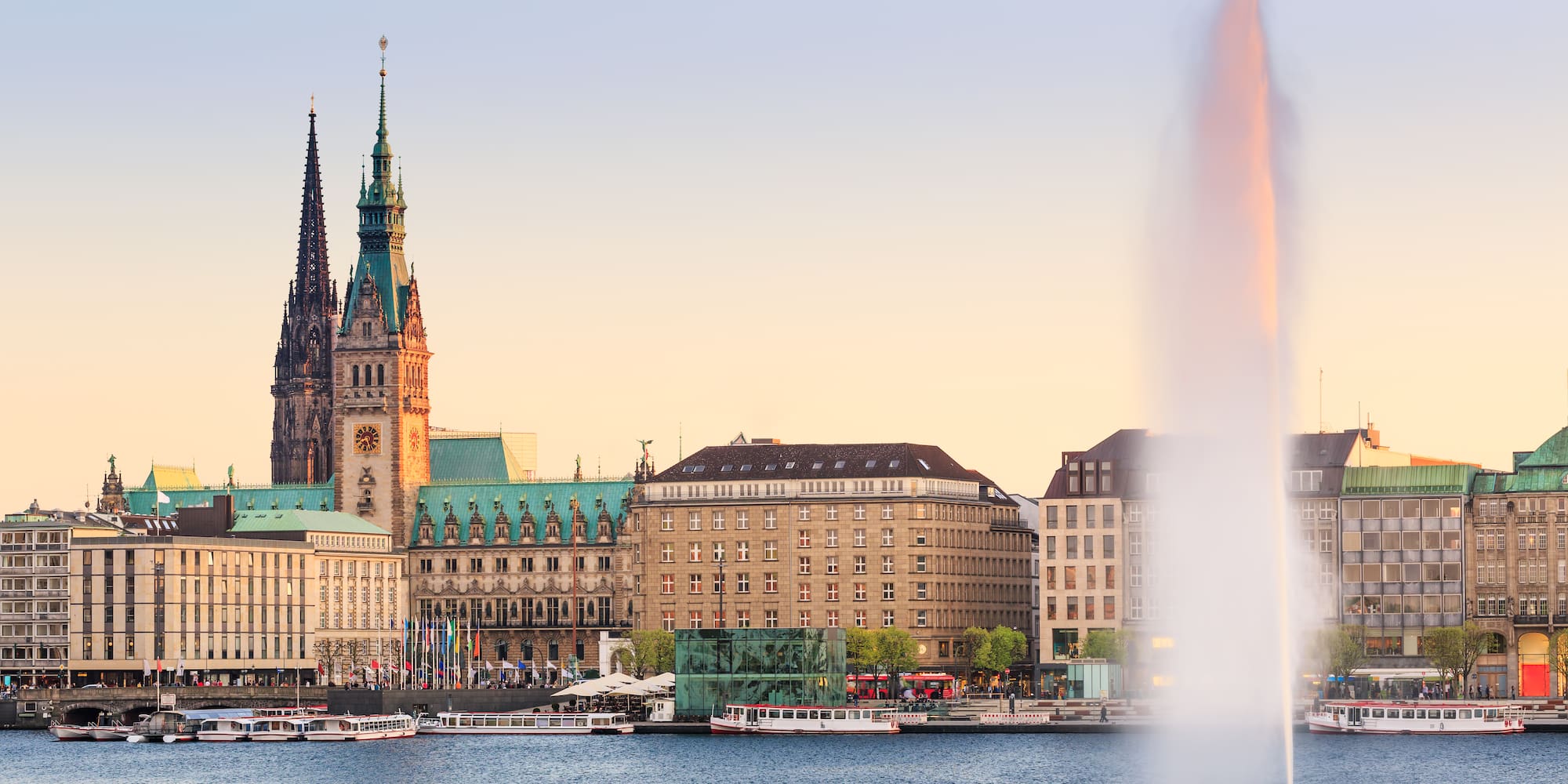a water fountain in front of a city