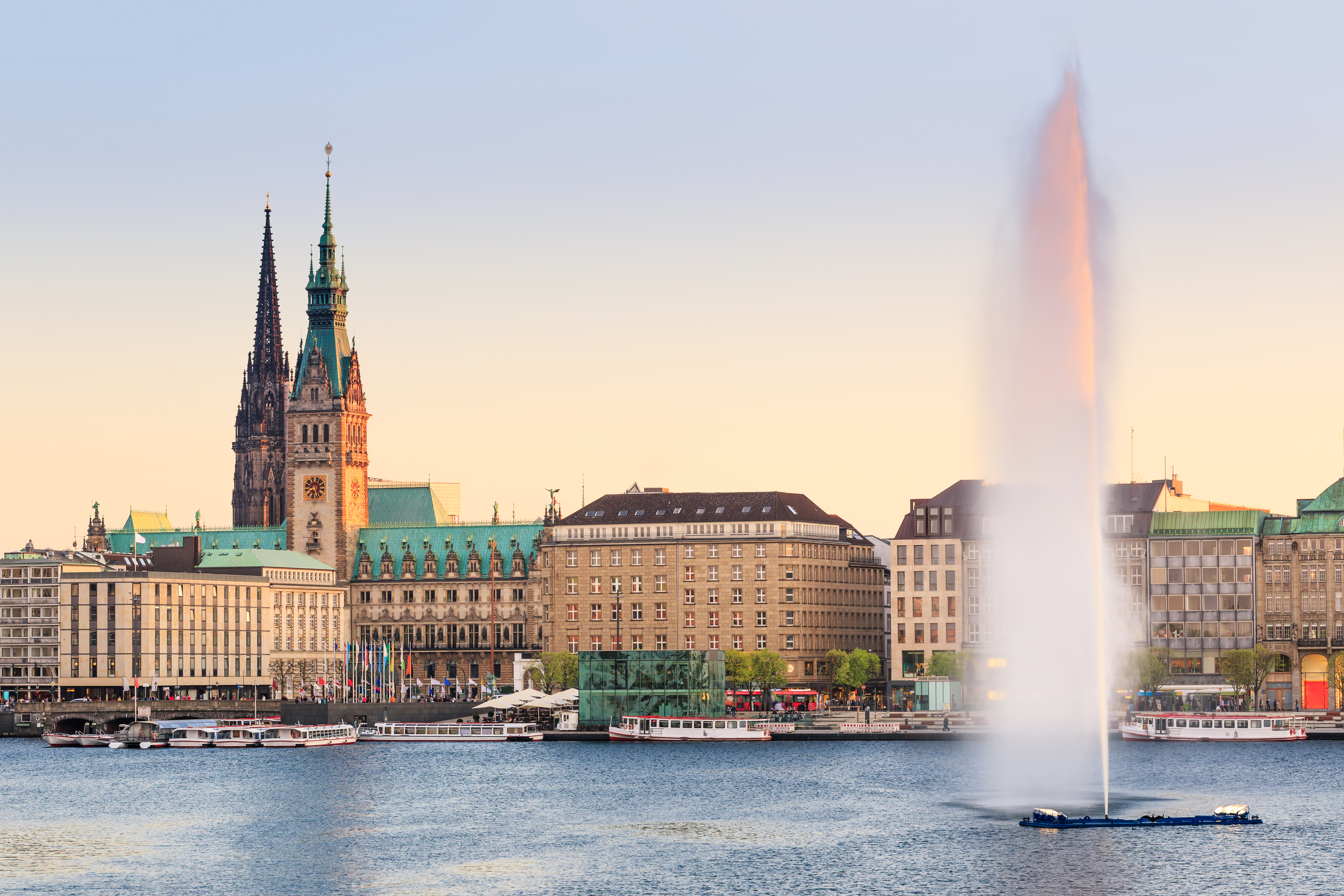 a water fountain in front of a city