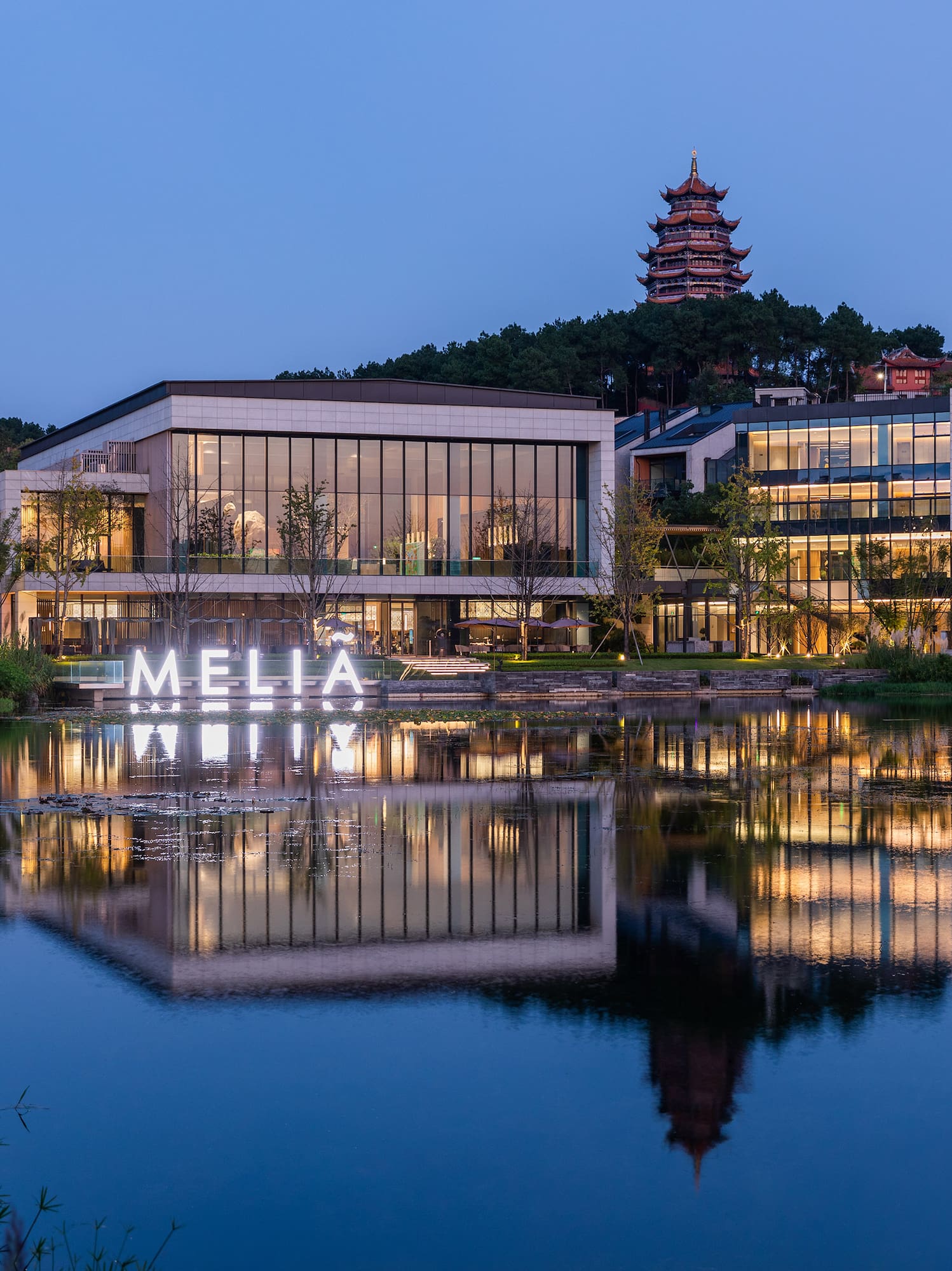 a building with lights on the water
