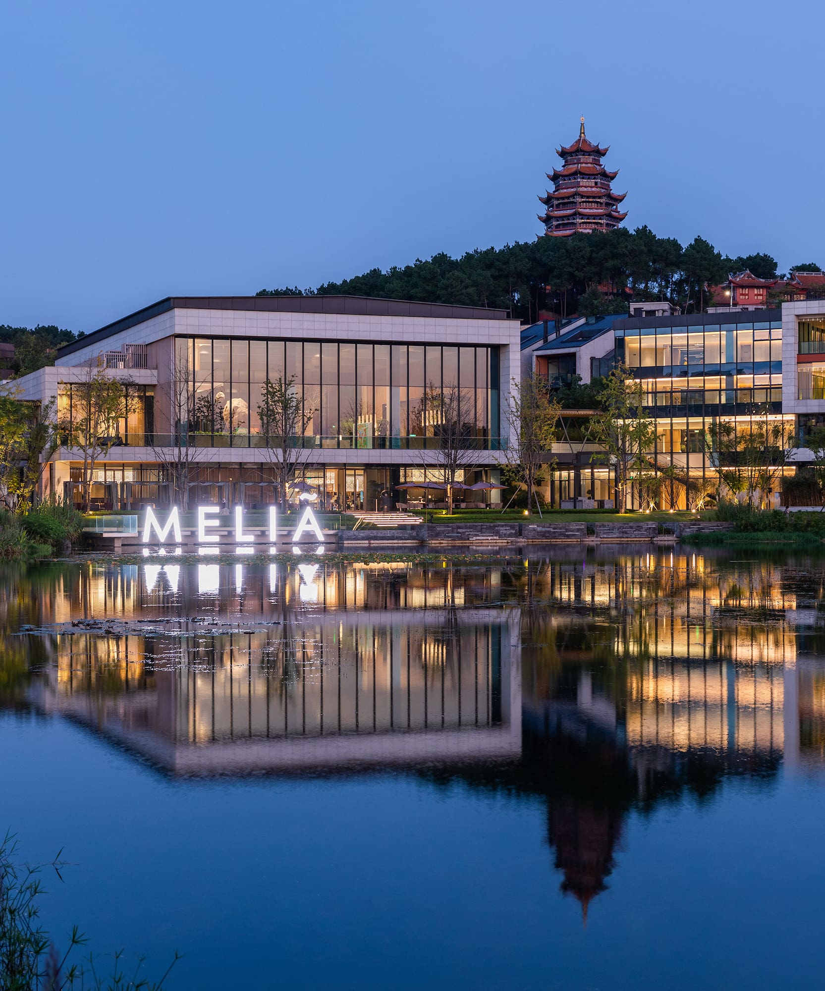 a building with lights on the water