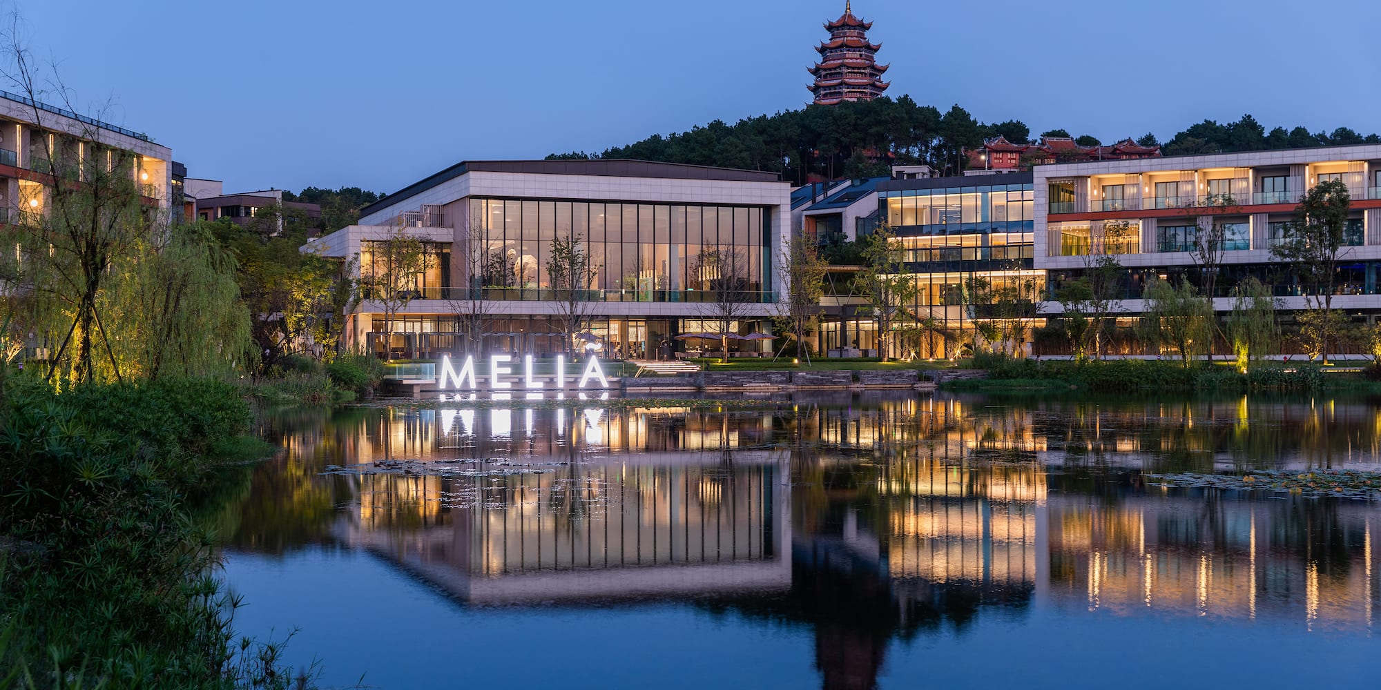a building with lights on the water