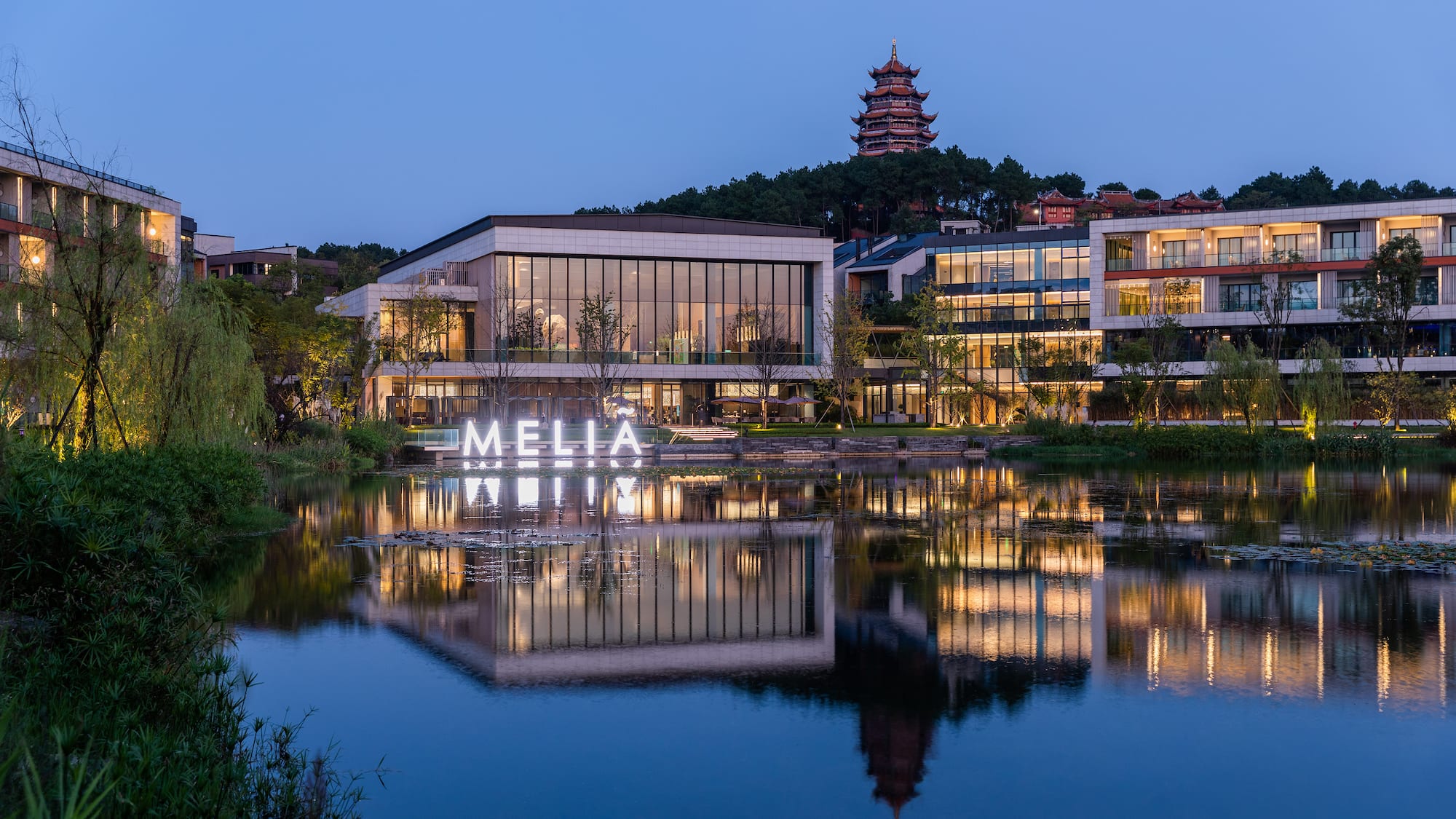 a building with lights on the water