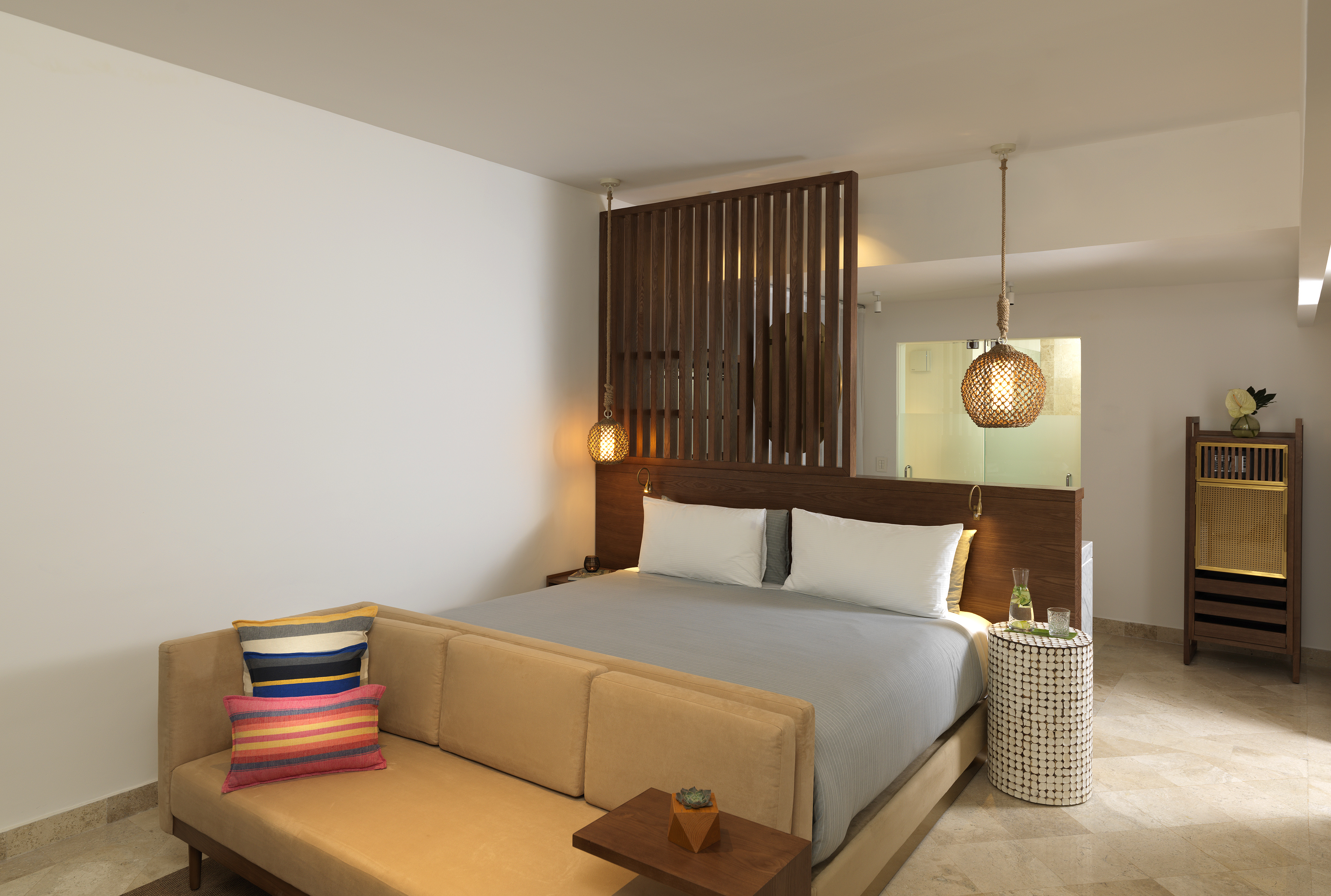 a bed with pillows and a table in a room