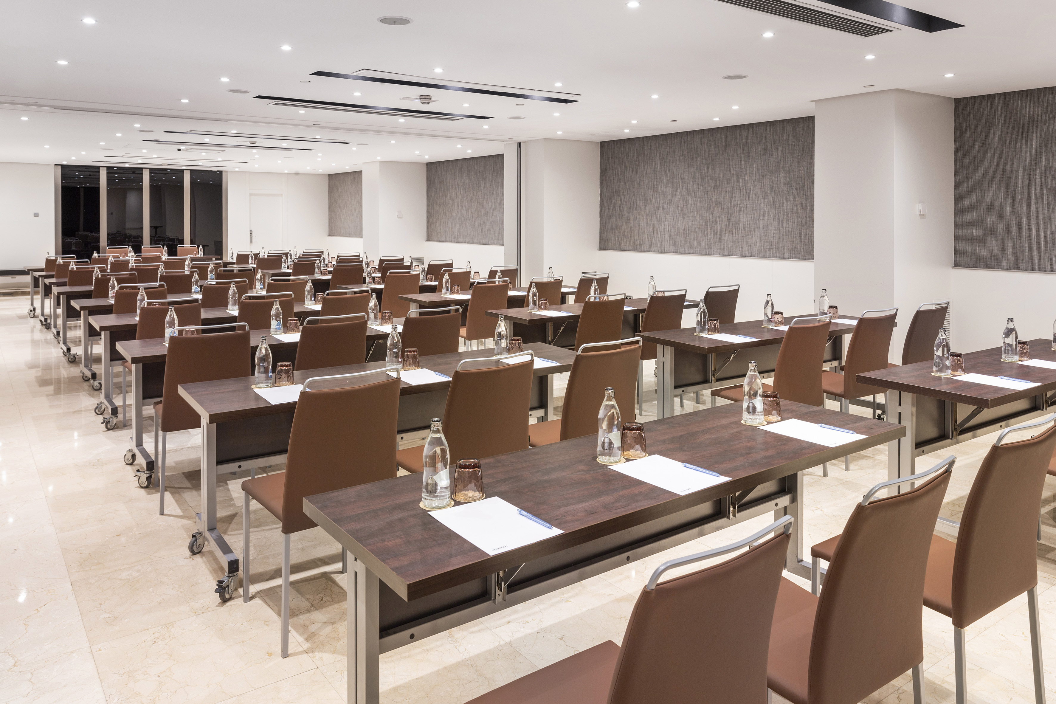 Spacious, modern conference room with classroom setup for events.